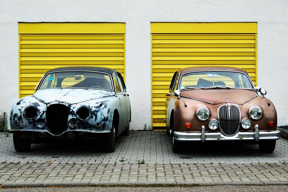 A junk car and a nice car representing comparing yourself to others