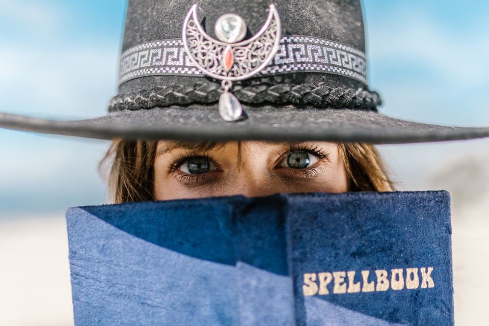 Woman holding a spellbook representing being a spiritual person