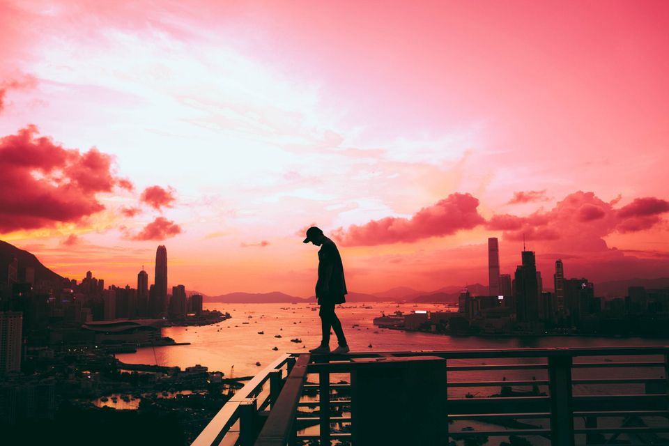 Man standing on a balcony representing Ralph Waldo Emerson's Self Reliance 