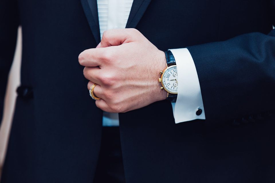 Man wearing nice suit and watch representing Dan Peña's secret to success