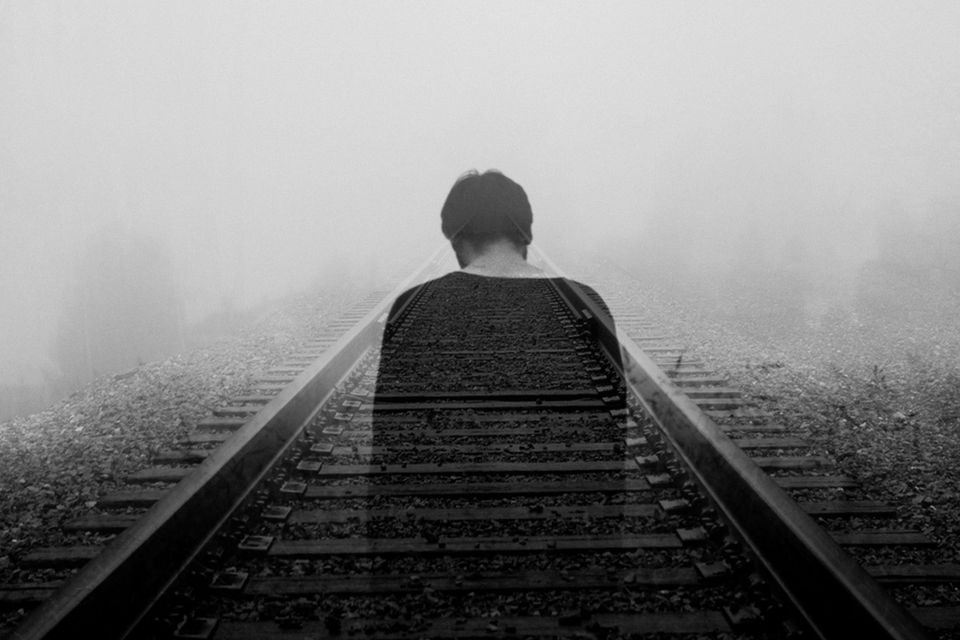 Ghost figure on a train track representing ghosts from your past