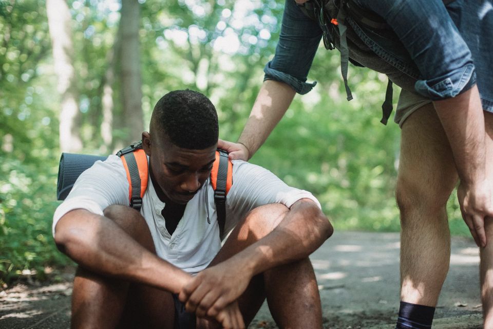 A man touching another man's shoulder representing encouragement