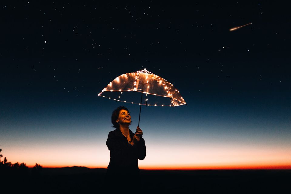 Happy woman with an umbrella representing the best years of your life