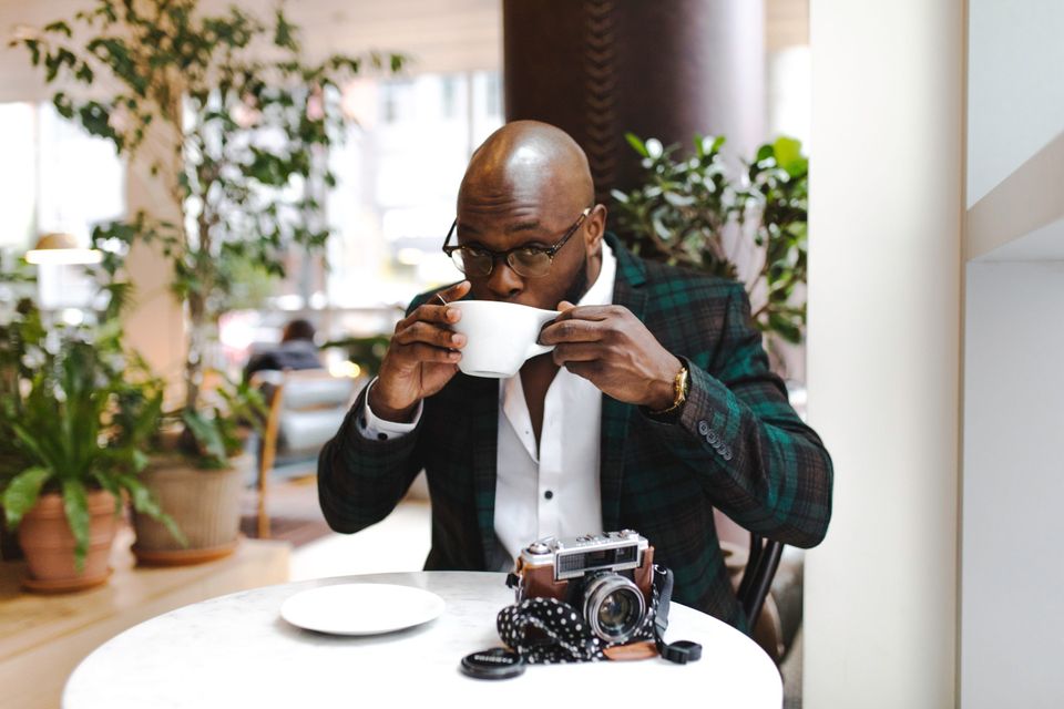 Confident Man drinking coffee representing being less nice 