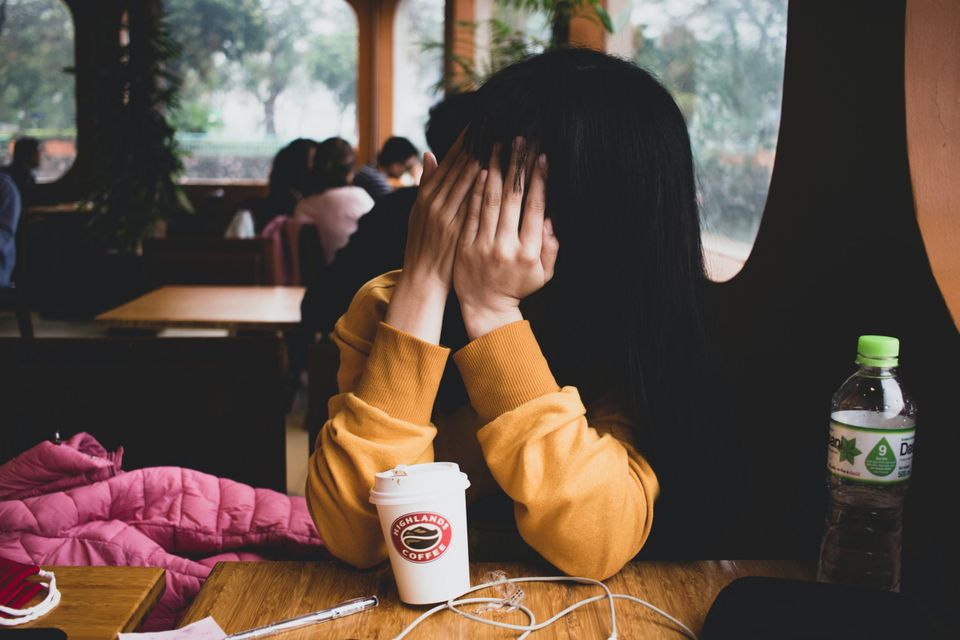 Girl covering her face representing being wrong