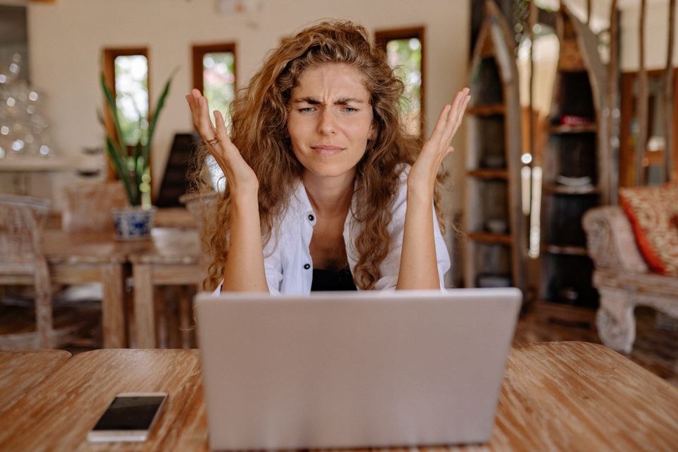 Angry woman on a laptop representing not being a slave to gurus, philosophers, or experts