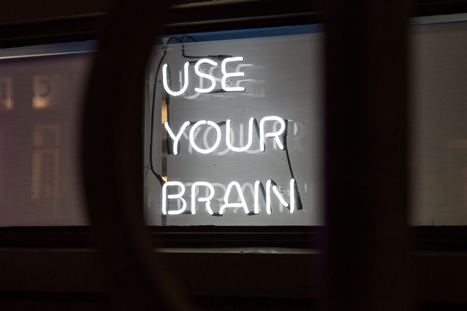 Neon sign saying "use your brain" in relation to dopamine detox.