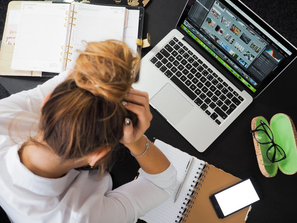 Woman at a desk stressing representing a hectic daily schedule