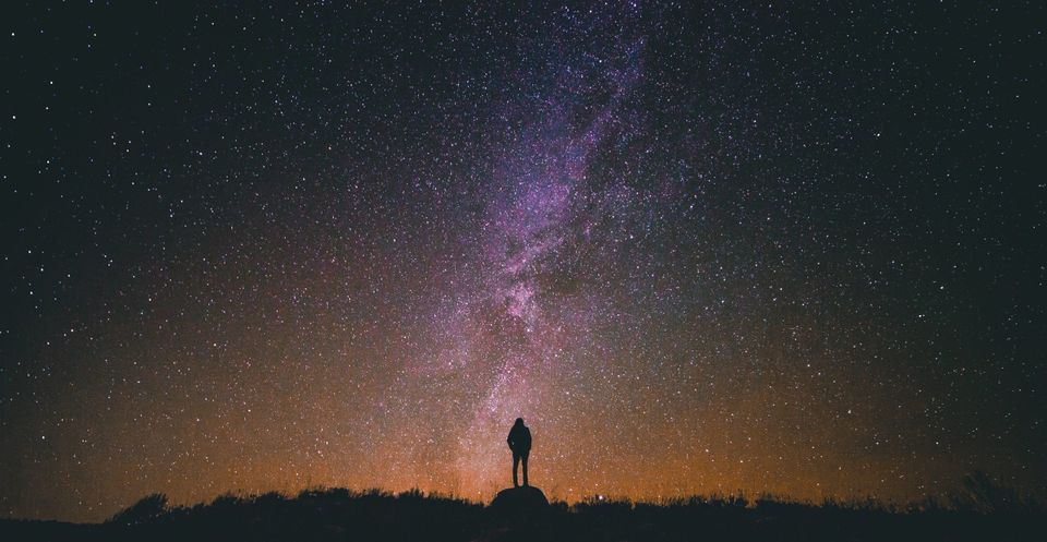 Man looking up in the sky representing synchronicity